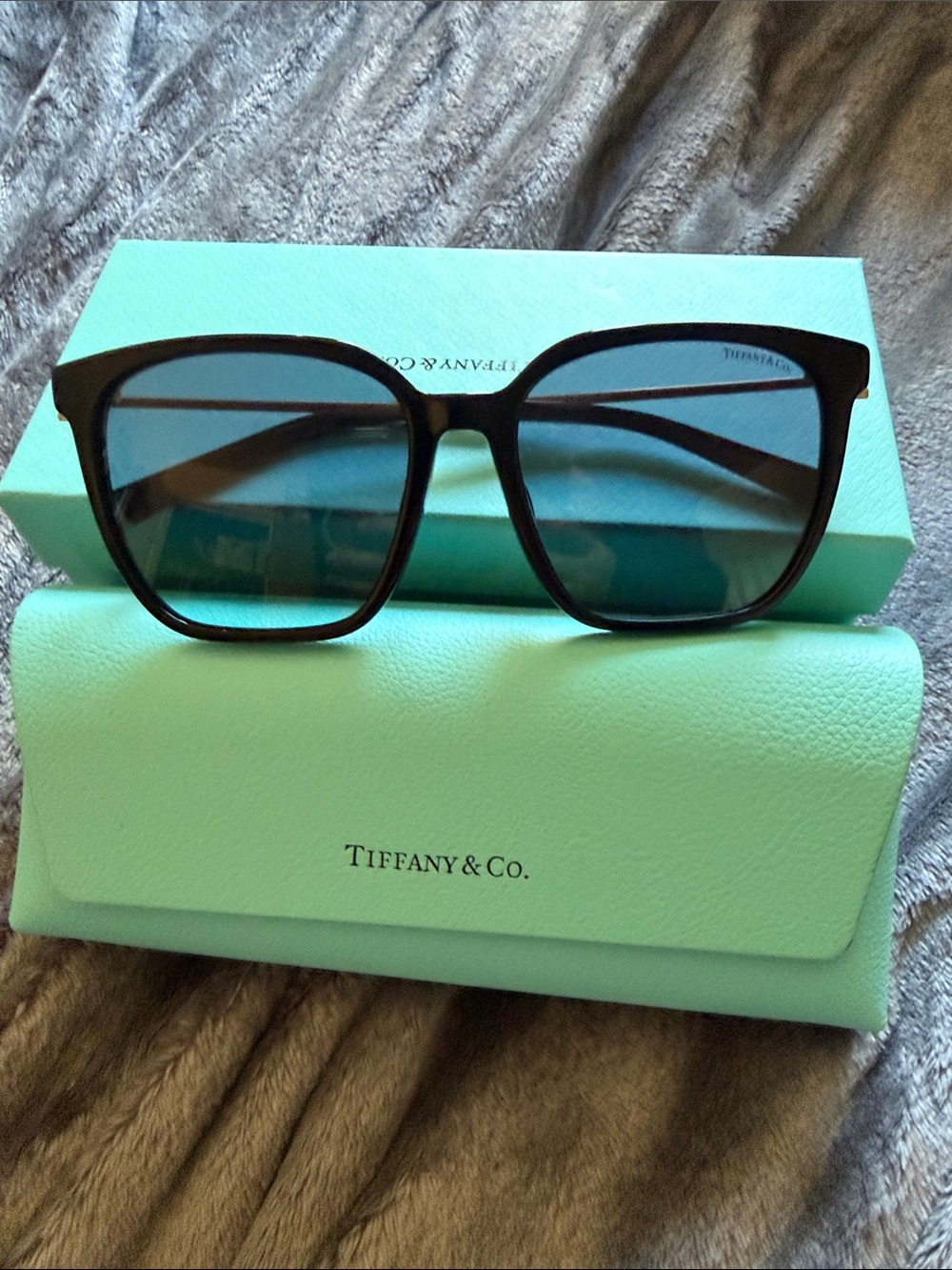 NWOT Tiffany & Co. Black Frame Sunglasses with Blue Lenses.